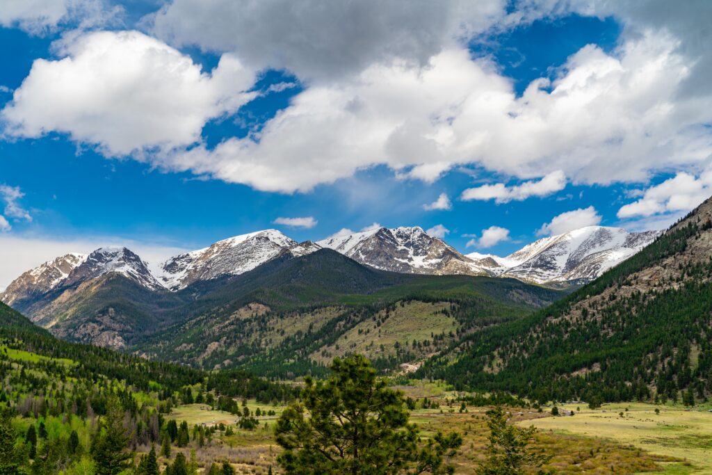 Shot Of Rocky Mountains In The National Park With Forests And Sky In The Background